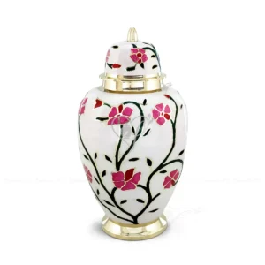 Blossoming Grace 11-inch solid brass cremation urn featuring a gloss white finish and hand-painted pink floral patterns with polished brass accents and a secure threaded lid.