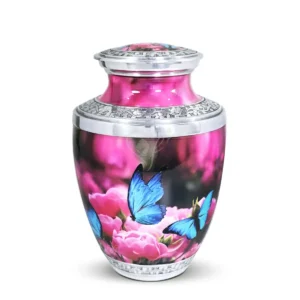 Rose Garden Butterflies 10-inch Treisty shape aluminum cremation urn featuring a High-Gloss Graphic Wrap of blue butterflies over pink roses with hand-engraved silver floral bands.