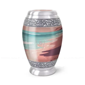 Shoreline Serenity 10-inch aluminum cremation urn featuring a High-Gloss Graphic Wrap of a peaceful beach scene with hand-engraved silver floral bands.