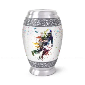 The Fullback 10-inch aluminum cremation urn featuring a High-Gloss Graphic Wrap of a rugby player with colorful paint splatters and hand-engraved silver floral bands.