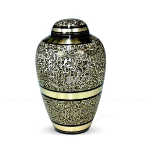 Aurelian Vine 10-inch contemporary dometop solid brass cremation urn with a black finish, hand-chiselled leaf patterns, and matte brass horizontal bands.