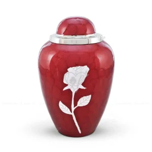 Garnet Grace 10-inch Dometop shaped premium brass cremation urn featuring a mottled red glossy Meena finish and a silver-tone rose motif.