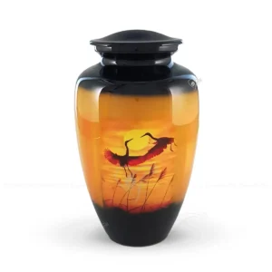 Golden Flight 10-inch classic aluminum cremation urn featuring a high-gloss sunset graphic wrap with cranes in flight and a black finish.