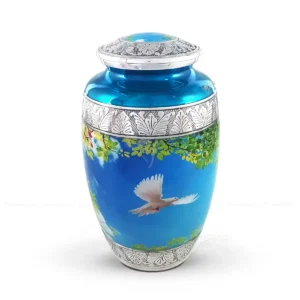 Skyward Serenity 10-inch aluminum cremation urn featuring a high-gloss scenic graphic wrap with a white dove and hand-engraved silver-tone floral bands.