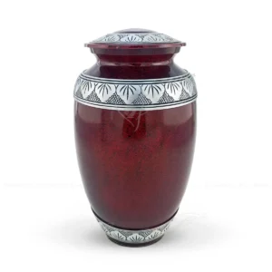 Ruby Arbor 10-inch aluminum cremation urn featuring a high-gloss deep red marble finish and hand-engraved silver-tone leaf bands.