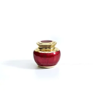 Eternal Spark 2-inch premium red brass keepsake urn in Glossy Red Meena with polished brass accents.